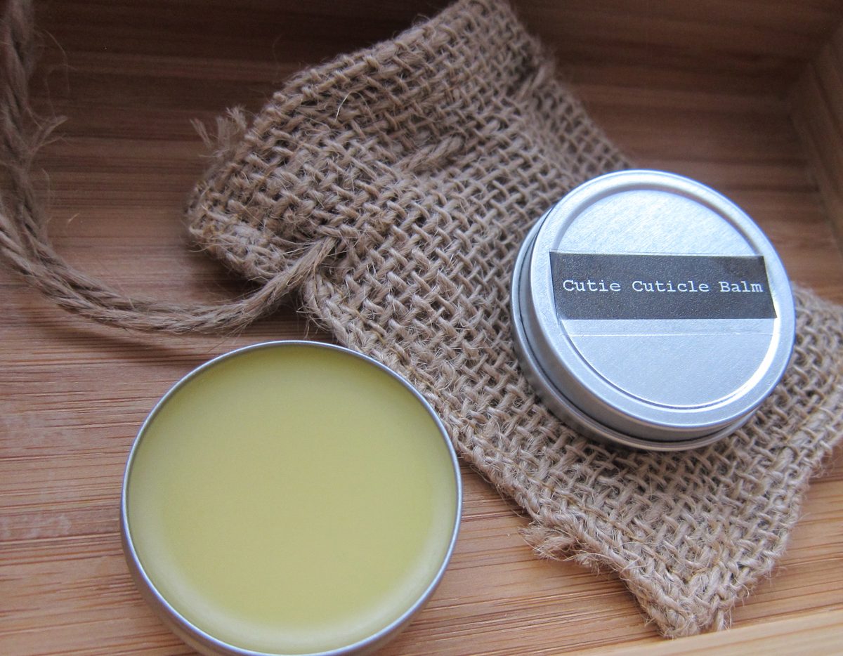 A tin of homemade balm on burlap